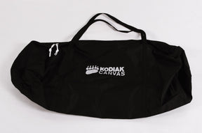 Kodiak Canvas black duffel bag with white logo, durable, spacious design for camping and travel.