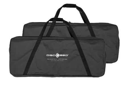 Black Disc-O-Bed extra large storage bags with sturdy handles for easy transportation of camping gear.