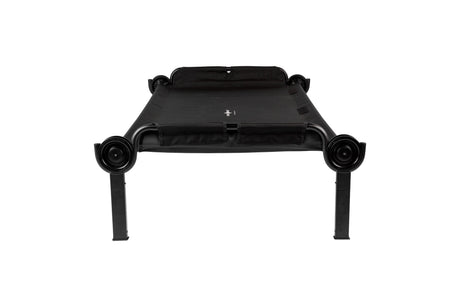 Black portable cot with sturdy frame and breathable fabric, ideal for camping and guest accommodations.