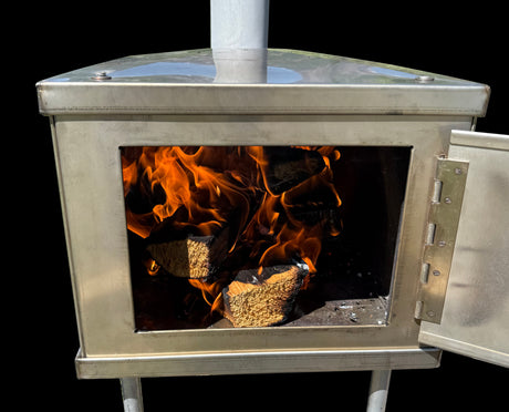 Stainless steel wood-burning stove with flames and logs visible inside, ideal for outdoor heating.