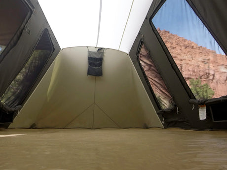 Spacious camping tent interior with large windows and tan waterproof floor, ideal for outdoor adventures.