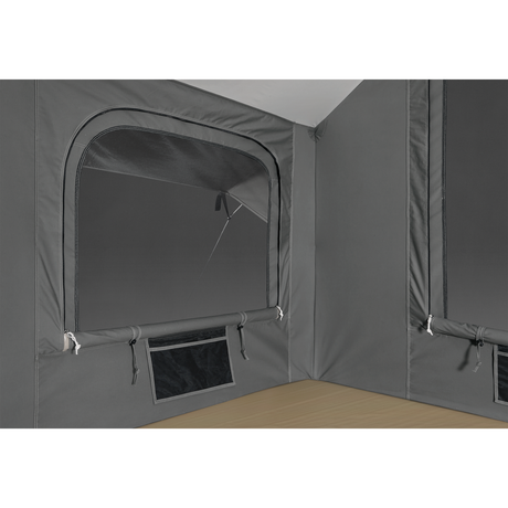 Interior view of a gray tent with mesh windows and a wooden floor.