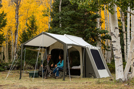 Spacious outdoor camping tent in gray and beige, featuring tall design and large windows for ventilation.