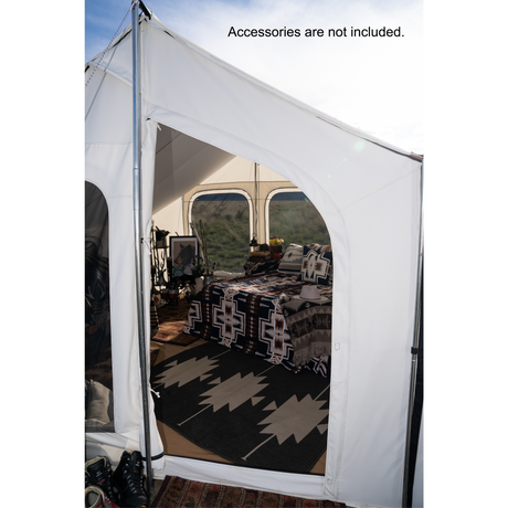 Glamping tent in white canvas showing entrance with a cozy interior with stylish bedding and decor.