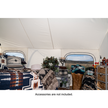 glamping tent additional interior view showing spacious layout with tall ceilings and windows. Accessories not included.