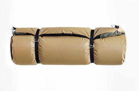 Durable tan sleeping bag with black straps, lightweight design for camping and outdoor adventures.