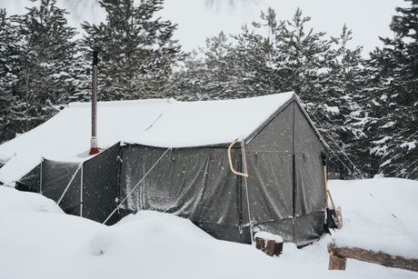 cabin lodge tent in a very snowy setting