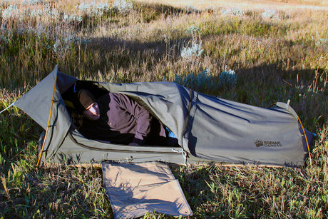 Kodiak Canvas tent in green color, durable material, compact design, ideal for camping and outdoor activities.