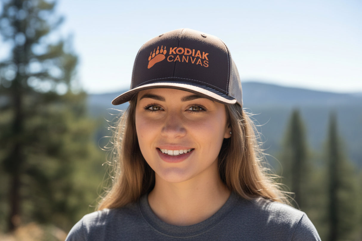 Person wearing a Kodiak Canvas cap with a scenic background