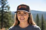 Person wearing a Kodiak Canvas cap with a scenic background