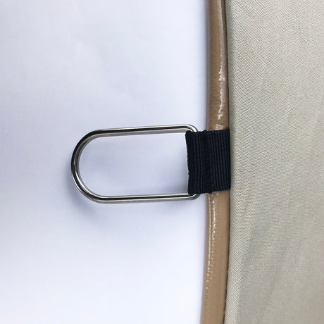 Tan fabric with metal D-ring and black strap, ideal for securing accessories or equipment.