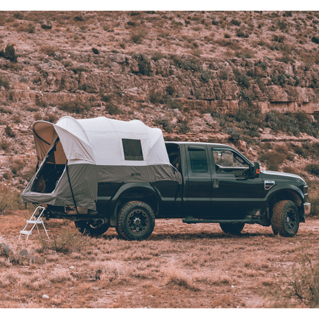 Outdoor truck tent in gray and white mounted on a pickup truck, perfect for camping adventures.