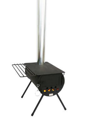 Portable black camping stove with chimney, grill rack, and visible flames for outdoor cooking.