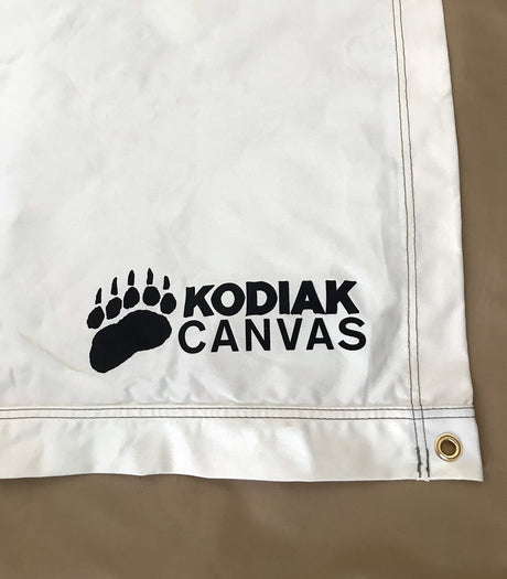 White Kodiak Canvas product featuring a bear paw logo, durable fabric and reinforced grommet design.