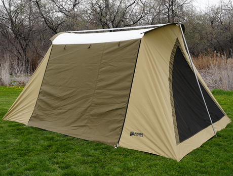 Kodiak Canvas 10x14 ft tent in tan color, durable cotton canvas with large mesh windows for ventilation.