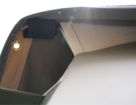 Interior view of a stylish gray handbag featuring a smooth finish and gold hardware details.